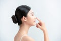 Beauty skincare woman smile happily and pointing her nose on white background Royalty Free Stock Photo