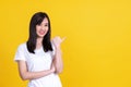 Beauty smiling brunette Asian woman pointing away and smiling Royalty Free Stock Photo