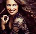 Beauty smiling rich woman in lace with dark red lipstick, flying hair close up
