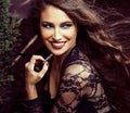 Beauty smiling rich woman in lace with dark red lipstick, flying hair close up