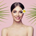 Beauty smiling spa model with natural make up and green leaves Royalty Free Stock Photo