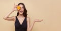 Beauty smiling woman with orange. Beautiful girl model with natural makeup, glowing facial skin and citrus fruit. Vitamin C Royalty Free Stock Photo