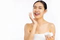 Beauty and spa concept, young asian woman portrait face with healthy skin applying cream on clean face white background Royalty Free Stock Photo