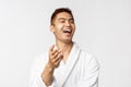 Beauty, spa and leisure concept. Portrait of enthusiastic happy young asian man, laughing at something funny, pointing Royalty Free Stock Photo