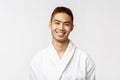 Beauty, spa and leisure concept. Young smiling, cheerful asian man grinning at camera delighted after awesome massage at