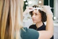 Woman having eyebrow correction procedure in beauty salon.