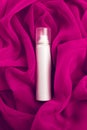 Beauty spray (aerosol) over pink (purple) vapory cloth Royalty Free Stock Photo