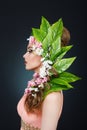 Beauty Spring girl with flowers hair. Beautiful model woman with flowers on her head. The Nature Of Hairstyle. Summer Royalty Free Stock Photo