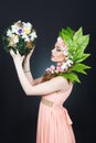 Beauty Spring girl with flowers hair. Beautiful model woman with flowers on her head. The Nature Of Hairstyle. Summer Royalty Free Stock Photo