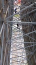 The beauty in the steel structure of the large billboards and the paint frame repair workers.