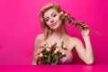 Beauty studio portrait. Beautiful model with pink rose flower, isolated on pink studio background. Charming young girl Royalty Free Stock Photo