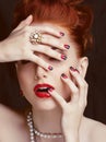 Beauty stylish redhead woman with hairstyle and manicure wearing jewelry pearl close up Royalty Free Stock Photo