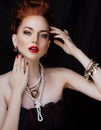 Beauty stylish redhead woman with hairstyle and manicure wearing jewelry pearl close up Royalty Free Stock Photo