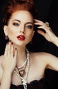 Beauty stylish redhead woman with hairstyle and manicure wearing jewelry pearl close up Royalty Free Stock Photo