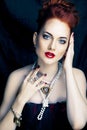 Beauty stylish redhead woman with hairstyle and manicure wearing jewelry pearl close up Royalty Free Stock Photo