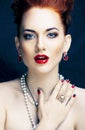 Beauty stylish redhead woman with hairstyle and manicure wearing jewelry pearl close up Royalty Free Stock Photo