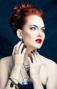 Beauty stylish redhead woman with hairstyle and manicure wearing jewelry pearl close up Royalty Free Stock Photo