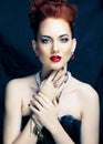 Beauty stylish redhead woman with hairstyle and manicure wearing jewelry pearl close up