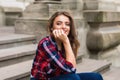 Beauty stylish young woman in dress sitting on steps in sunny bright summer day travel Royalty Free Stock Photo