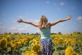 Beauty sunlit woman on yellow sunflower field Freedom and happiness concept. Happy girl outdoors Royalty Free Stock Photo