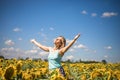 Beauty sunlit woman on yellow sunflower field Freedom and happiness concept. Happy girl outdoors Royalty Free Stock Photo