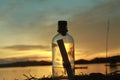 The beauty of the sunset with a bottle filled with letters