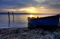 Beauty sunset with the lonely blue boat Royalty Free Stock Photo