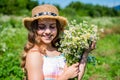 Beauty is taking time to get pampered. Happy girl smile with chamomile bunch. Beauty look of small kid. Natural skincare