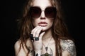 Beauty tattooed girl in sunglasses and jewelry