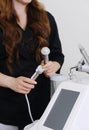 Beauty Technician Preparing Advanced Facial Equipment