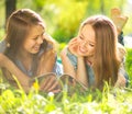 Beauty teen girls reading magazine outdoors Royalty Free Stock Photo