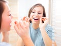 Beauty teenage girl flossing her teeth Royalty Free Stock Photo