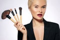 Beauty Treatment. Girl with Makeup Brushes. Fashion Make-up for Woman. Makeover. Make-up Artist Applying Visage Royalty Free Stock Photo