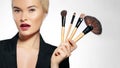 Beauty Treatment. Girl with Makeup Brushes. Fashion Make-up for Woman. Makeover. Make-up Artist Applying Visage Royalty Free Stock Photo