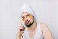 Beauty treatment, skin care, metrosexual concept. Handsome bearded man with golden eye patches under eyes and white Royalty Free Stock Photo