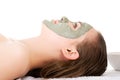 Beauty treatment in spa salon. Woman with facial clay mask. Royalty Free Stock Photo