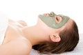 Beauty treatment in spa salon. Woman with facial clay mask. Royalty Free Stock Photo