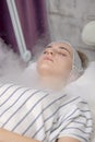 Beauty treatment of young female face, ozone facial steamer Royalty Free Stock Photo
