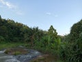 The beauty of the views of hills and rivers and trees against a blue sky background Royalty Free Stock Photo