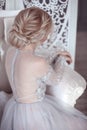 Beauty wedding hairstyle. Bride. Blond girl with curly hair styling. Back view of elegant lady in bridal dress. Royalty Free Stock Photo