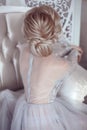 Beauty wedding hairstyle. Bride. Blond girl with curly hair styling. Back view of elegant lady in bridal dress.