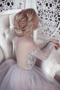 Beauty wedding hairstyle. Bride. Blond girl with curly hair styling. Back view of elegant lady in bridal dress. Royalty Free Stock Photo