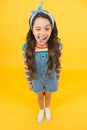 Beauty is whatever brings joy. Playful child grimace yellow background. Little girl in casual style. Beauty look of