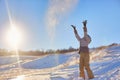 Beauty Winter Girl Blowing Snow in frosty winter Park. Outdoors. Flying Snowflakes. Sunny day. Backlit. Beauty young woman Having Royalty Free Stock Photo