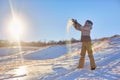 Beauty Winter Girl Blowing Snow in frosty winter Park. Outdoors. Flying Snowflakes. Sunny day. Backlit. Beauty young woman Having Royalty Free Stock Photo