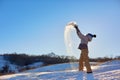 Beauty Winter Girl Blowing Snow in frosty winter Park. Outdoors. Flying Snowflakes. Sunny day. Backlit. Beauty young woman Having Royalty Free Stock Photo