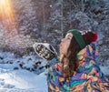 Beauty Winter Girl Blowing Snow in frosty winter Park. Outdoors. Flying Snowflakes. Sunny day. Backlit. Joyful Beauty