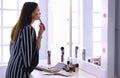Beauty woman applying makeup. Beautiful girl looking in the mirror and applying cosmetic with a big brush Royalty Free Stock Photo