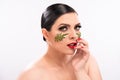 Beauty woman. Beautiful female model with perfect clean fresh skin with green leaves patches on her face. Skin care Royalty Free Stock Photo