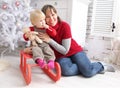 Beauty woman and child indoor on sledge at christmas decoration with xmas text Royalty Free Stock Photo